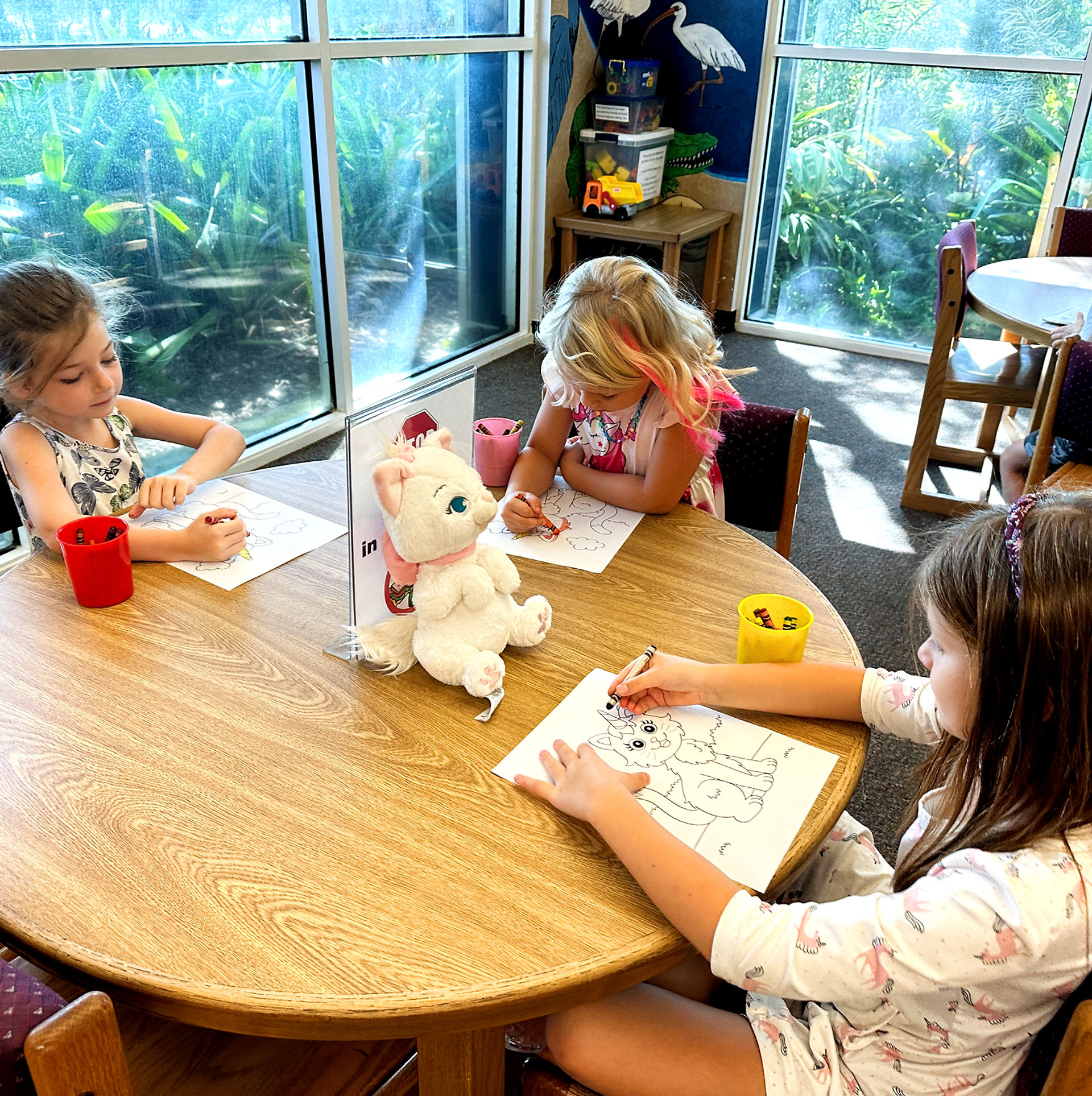Elementary students engaged in colorful classroom learning activities at 3 Oaks Academy